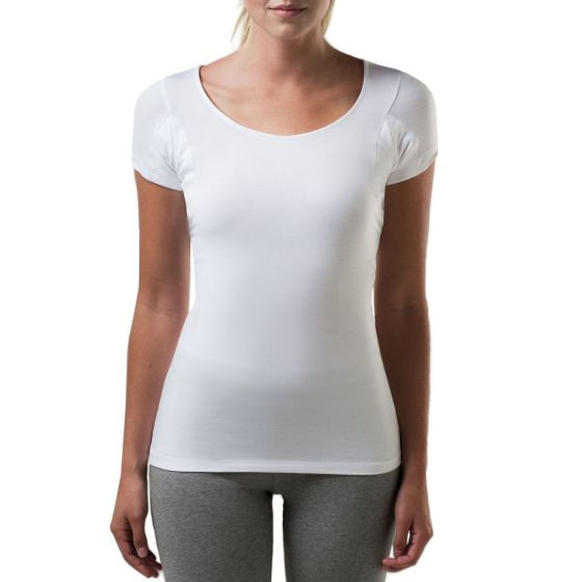 A woman wearing a white slim fit scoop neck undershirt.